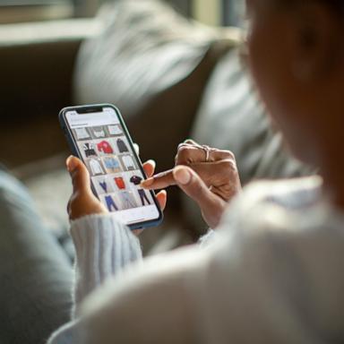 [PHOTO: Stock photo of a person shopping on their mobile device.]