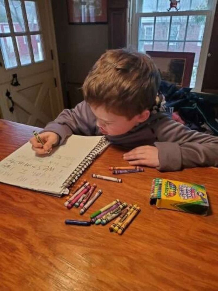 PHOTO: Cameron France, 7, of Massachusetts, writes handmade cards to seniors who are quarantined in assisted living facilities amid the coronavirus crisis.
