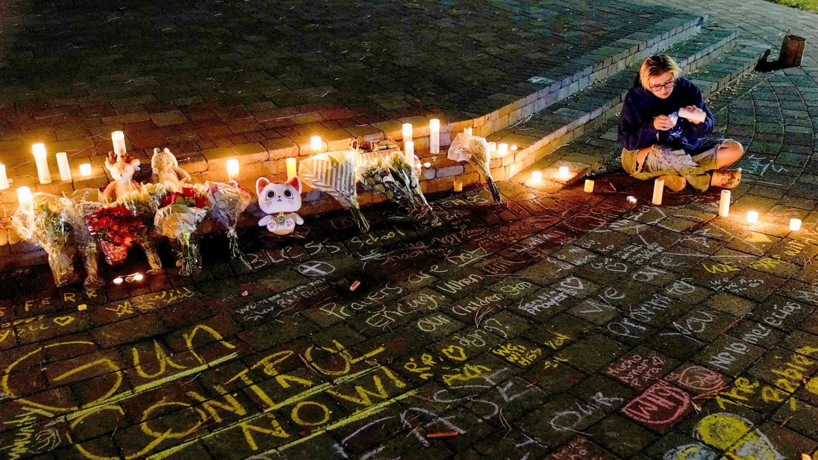 PHOTO: A woman lights a candle during a candlelight vigil at Drake Park for victims of the Silver Rail Elementary School shooting, in Bend, Oregon, October 15, 2026.
