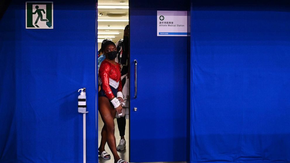 PHOTO: Simone Biles of the United States leaves a medical station during the women's gymnastics team final, July 27, 2021, at the 2020 Summer Olympics in Tokyo.