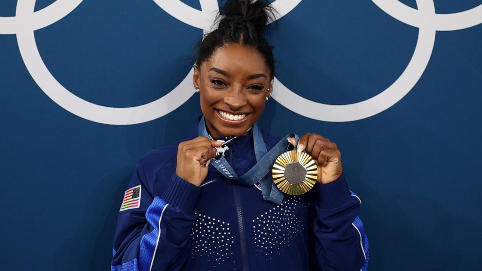 PHOTO: Gold medalist Simone Biles of Team United States poses with the Olympic Rings during the Artistic Gymnastics Women's All-Around Final medal ceremony on day six of the Olympic Games Paris 2024, Aug. 1, 2024, in Paris.