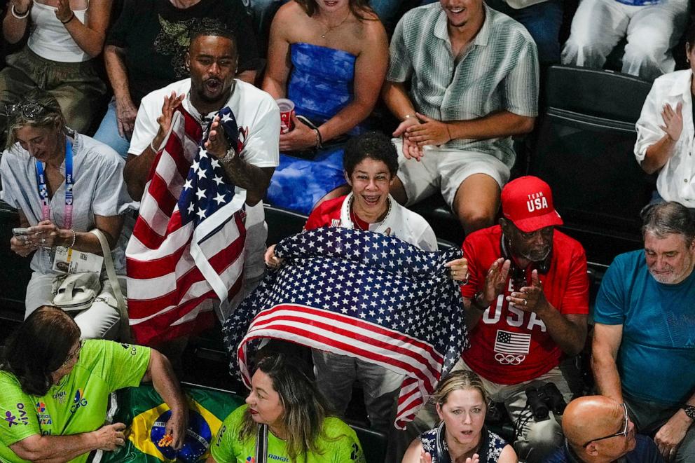 PHOTO: Simone Biles' husband Jonathan Owens along with her mother and father Nellie and Ron Biles cheer as she is introduced during the women's artistic gymnastics team finals at the 2024 Summer Olympics, on July 30, 2024, in Paris.