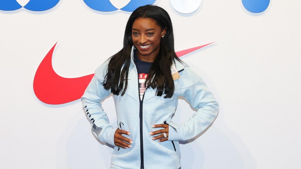 PHOTO: Simone Biles tries on clothes at the Team USA Welcome Experience Ahead of Paris 2024, July 22, 2024, in Paris.