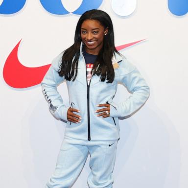 PHOTO: Simone Biles tries on clothes at the Team USA Welcome Experience Ahead of Paris 2024, July 22, 2024, in Paris.