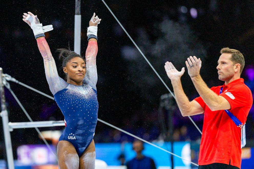 PHOTO: In this Oct. 4, 2023, file photo, Simone Biles reacts after performing her uneven bars routine applauded by coach Laurent Landi during the Women's Team Final at the Artistic Gymnastics World Championships-Antwerp 2023, in Antwerp, Belgium.