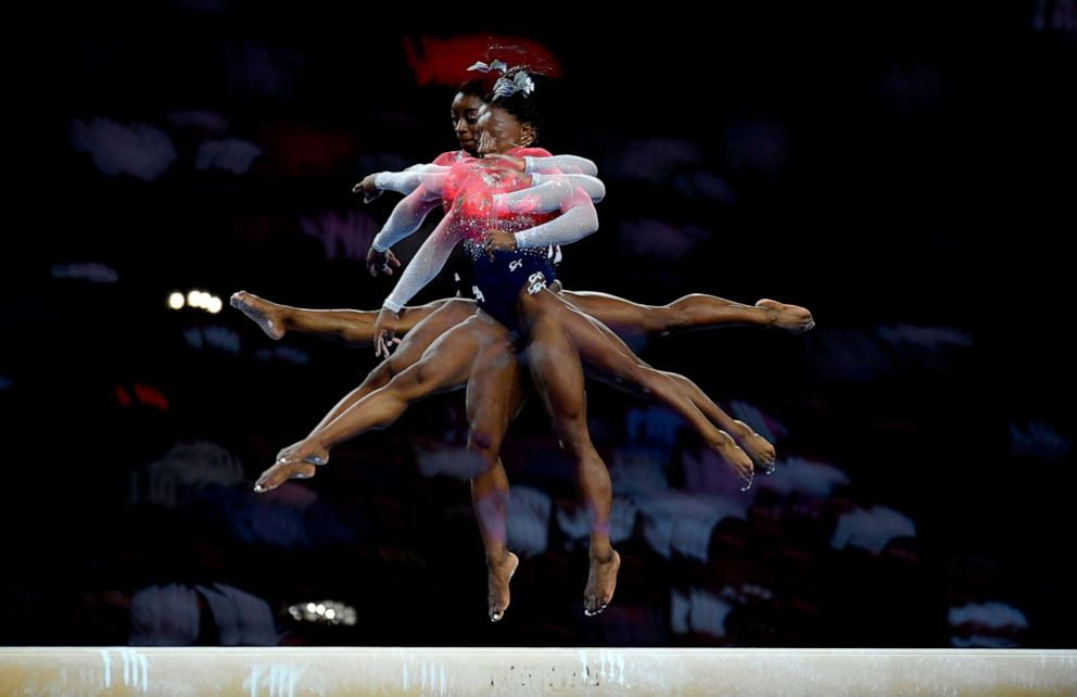 PHOTO: This multi-exposure picture shows USA's Simone Biles performing on the beam during the women's team final at the FIG Artistic Gymnastics World Championships at the Hanns-Martin-Schleyer-Halle in Stuttgart, Germany, Oct. 8, 2019.