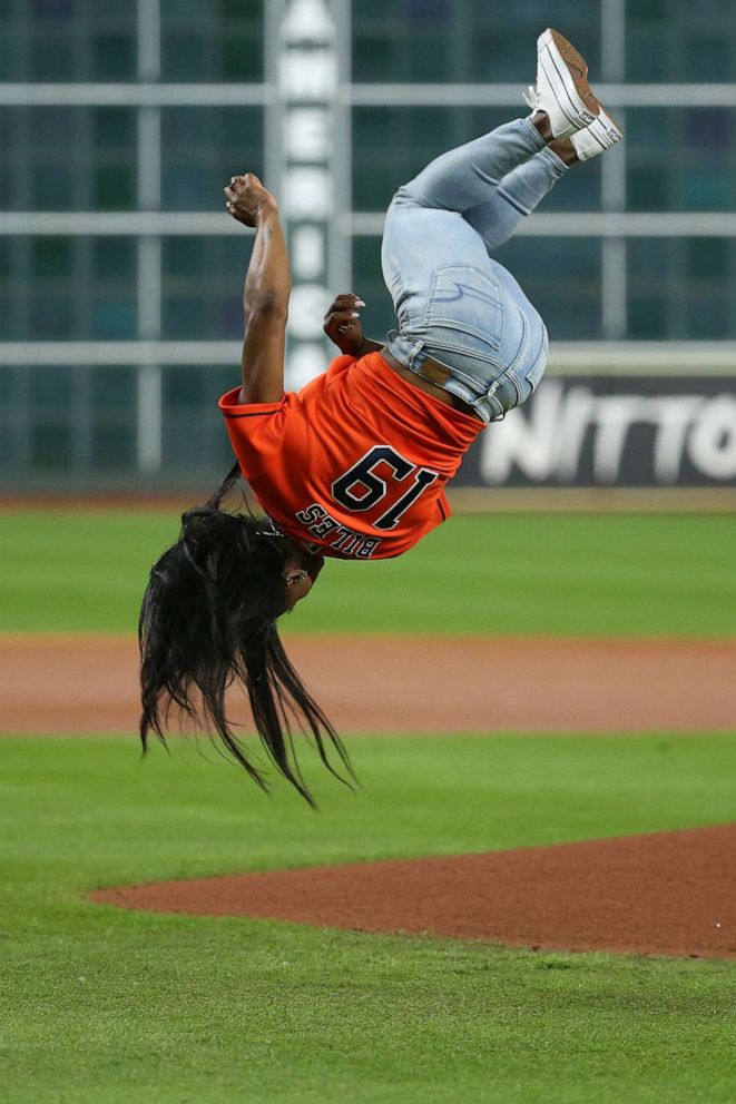 Olympic gymnastics gold medalist Simone Biles performs a flip before throwing out a ceremonial first pitch prior to game two of the 2019 World Series between the Houston Astros and the Washington Nationals at Minute Maid Park, Oct 23, 2019 in Houston.