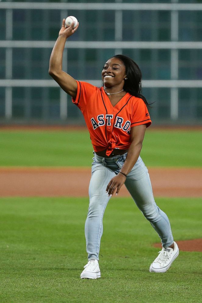 PHOTO:Olympic gymnastics gold medalist Simone Biles throws out a ceremonial first pitch prior to game two of the 2019 World Series between the Houston Astros and the Washington Nationals at Minute Maid Park, OCt. 23, 2019.