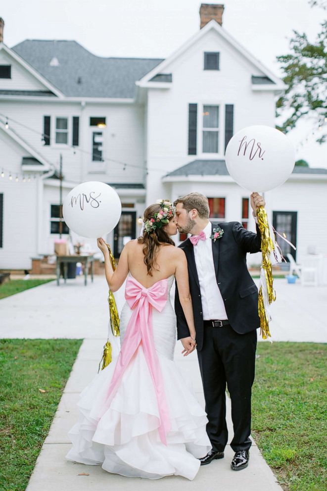 PHOTO: Carrie and John Michael Simpson pose for a photo after getting married in a parking lot in September.