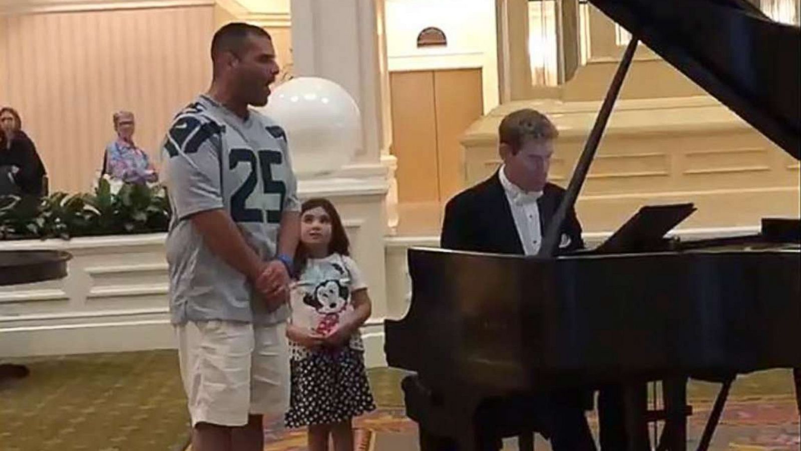 PHOTO: Dad goes viral after belting out "Ave Maria" in the lobby of Disney's Polynesian Village Resort next to his 6-year-old daughter.