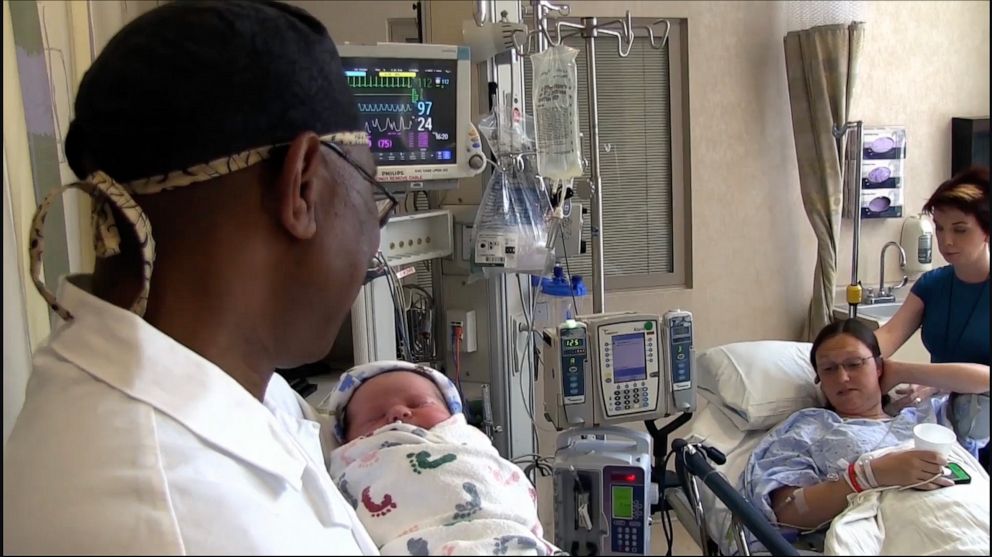 PHOTO: Dr. Andrew Carey Jaja sings to a newborn baby at at UPMC Magee-Womens Hospital in Pittsburgh.