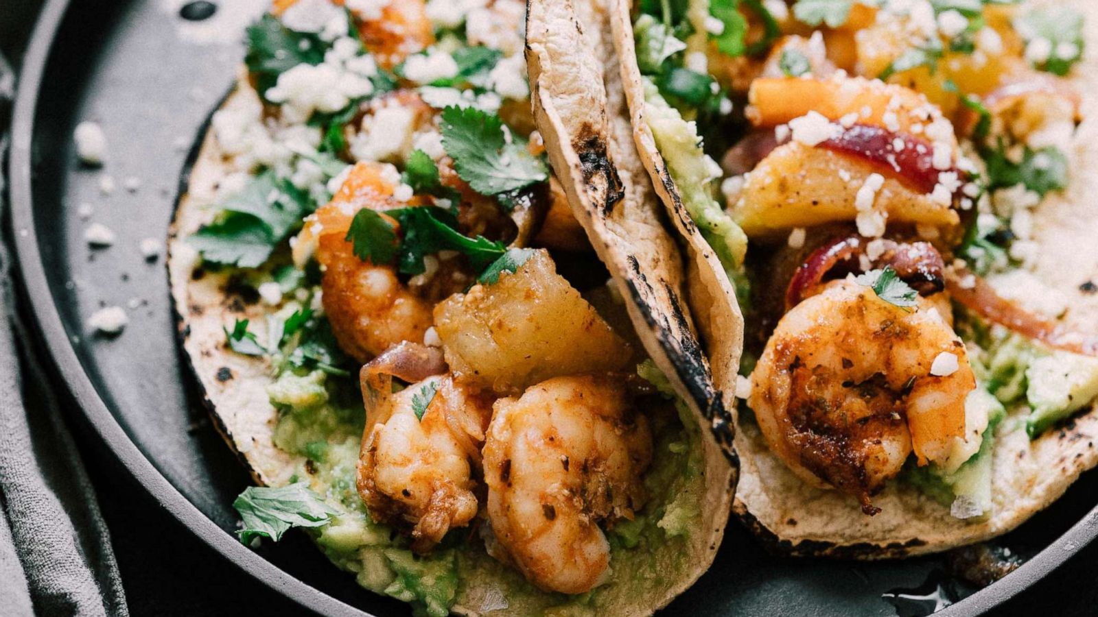 PHOTO: Sheet-pan shrimp and pineapple tacos with avocado.