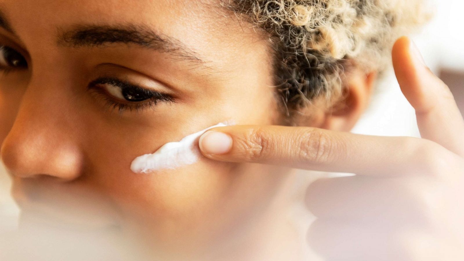 PHOTO: A woman applies cream to her face in an undated stock image.