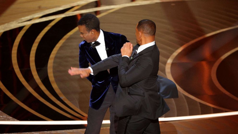 PHOTO: Will Smith (R) hits at Chris Rock as Rock spoke on stage during the 94th Academy Awards in Hollywood, Los Angeles, March 27, 2022.