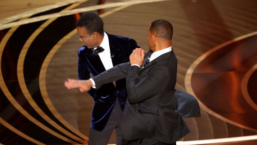 PHOTO: Will Smith (R) hits at Chris Rock as Rock spoke on stage during the 94th Academy Awards in Hollywood, Los Angeles, March 27, 2022.
