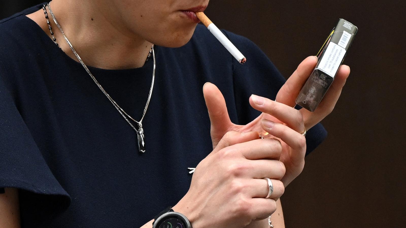 PHOTO: A woman is seen smoking a cigarette in central London on June 9, 2022.