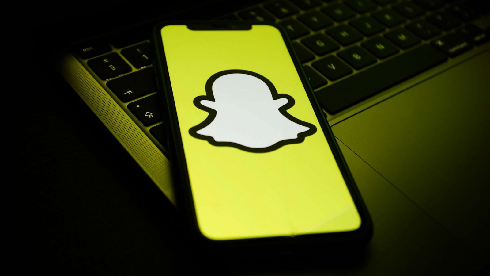 PHOTO: A Snapchat logo is displayed on a phone screen and a laptop keyboard in this illustration photo.