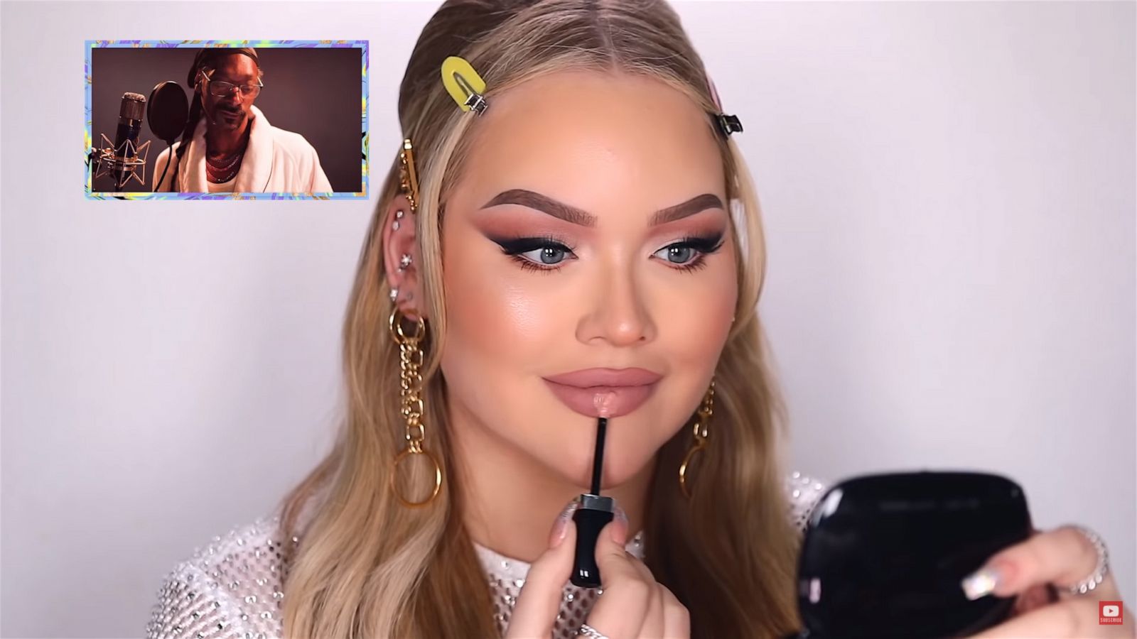 PHOTO: Nikkie de Jager applies makeup to her face in a makeup tutorial posted to YouTube while Snoop Dogg narrates in the video titled, "SNOOP DOGG NARRATES MY MAKEUP ROUTINE!"