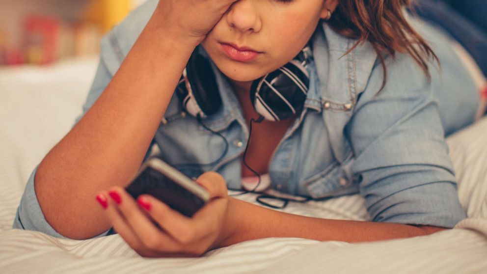 PHOTO: Teenager on iphone cellphone social media in undated stock photo. 