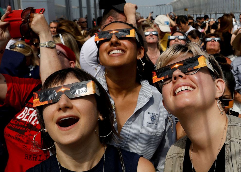 PHOTO: People watch a solar eclipse from the observation deck of The Empire State Building in New York City, Aug. 21, 2017.