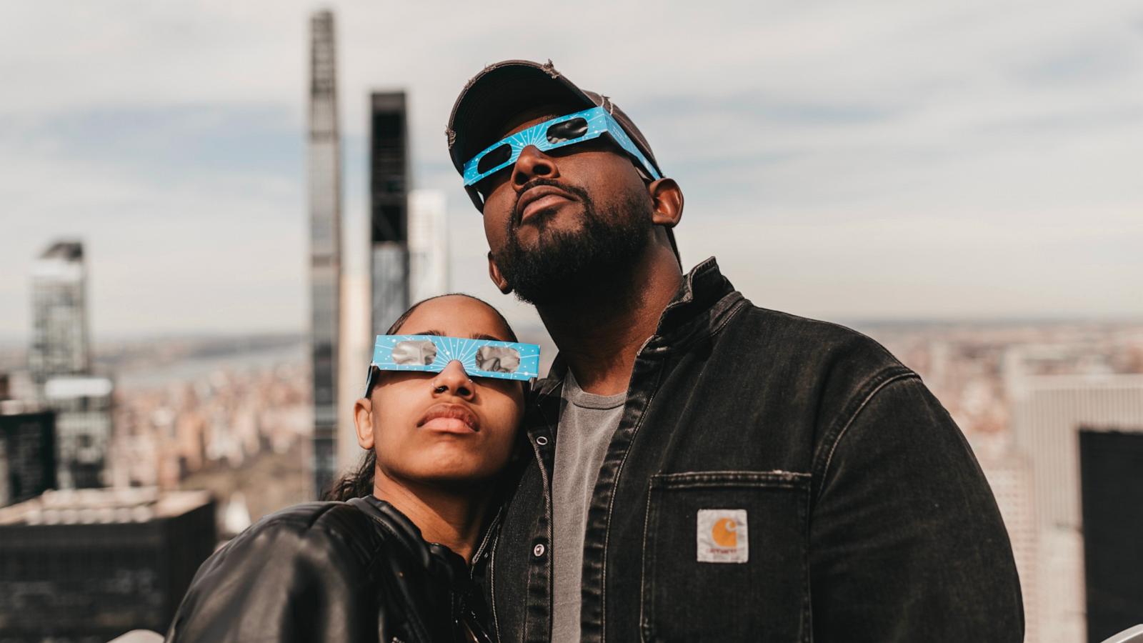 PHOTO: Spectators watch a solar eclipse from the Top of the Rock at Rockefeller Center on April 08, 2024 in New York City.