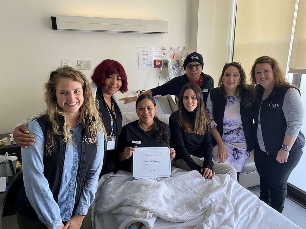 PHOTO: Teachers and staff from Idea Bluff Springs school in Austin, Texas, visit Carina Soto-Rodriguez, center, and her husband, Andres, back, at the hospital.