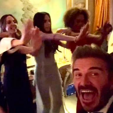 PHOTO: David Beckham watches the Spice Girls perform at Victoria Beckham's 50th birthday.