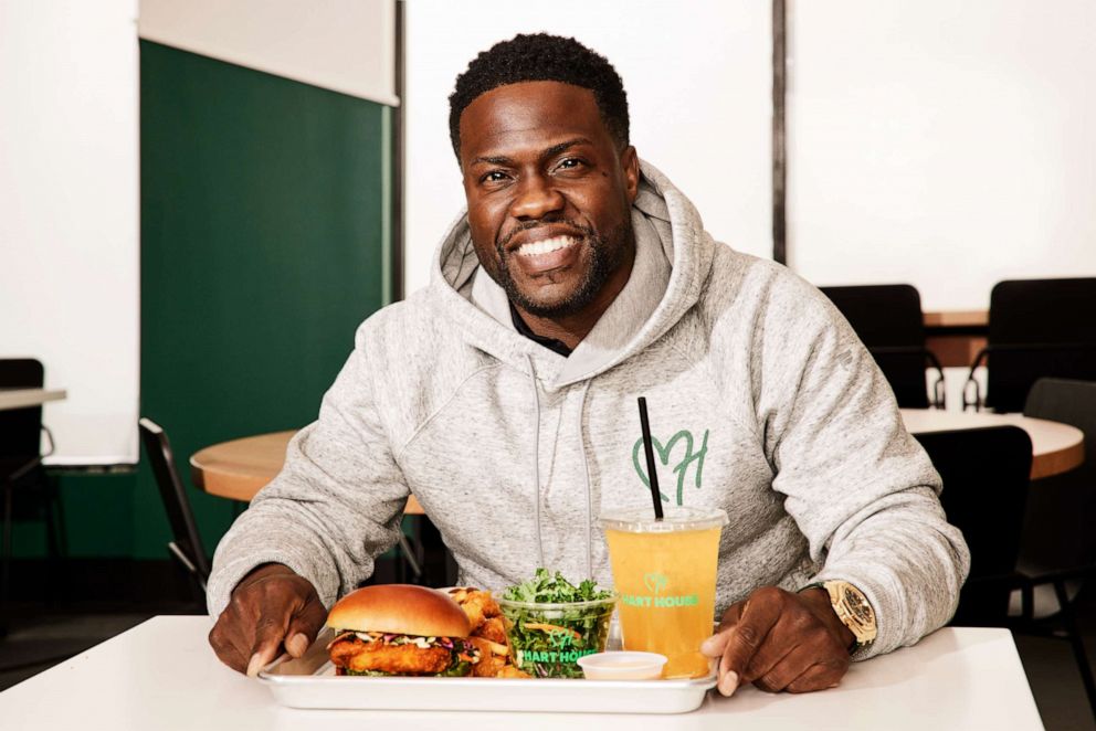 PHOTO: Kevin Hart enjoying his favorite item from the plant-based menu at Hart House, the spicy chicken sandwich.