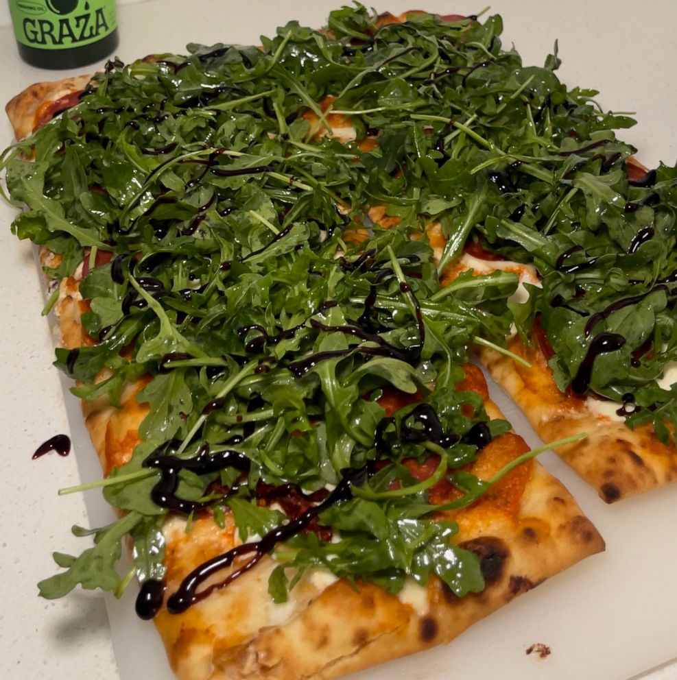 PHOTO: A homemade spicy pizza topped with arugula using Trader Joe's ingredients.