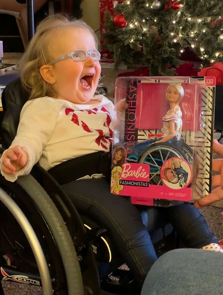 PHOTO: Ella Rogers was born with spina bifida and uses a wheelchair. When her mom and dad gifted her a Barbie who also uses a wheelchair, the doll became her new favorite toy. Ella's mom Lacey Rogers of Ohio, captured Ella interacting with the doll.