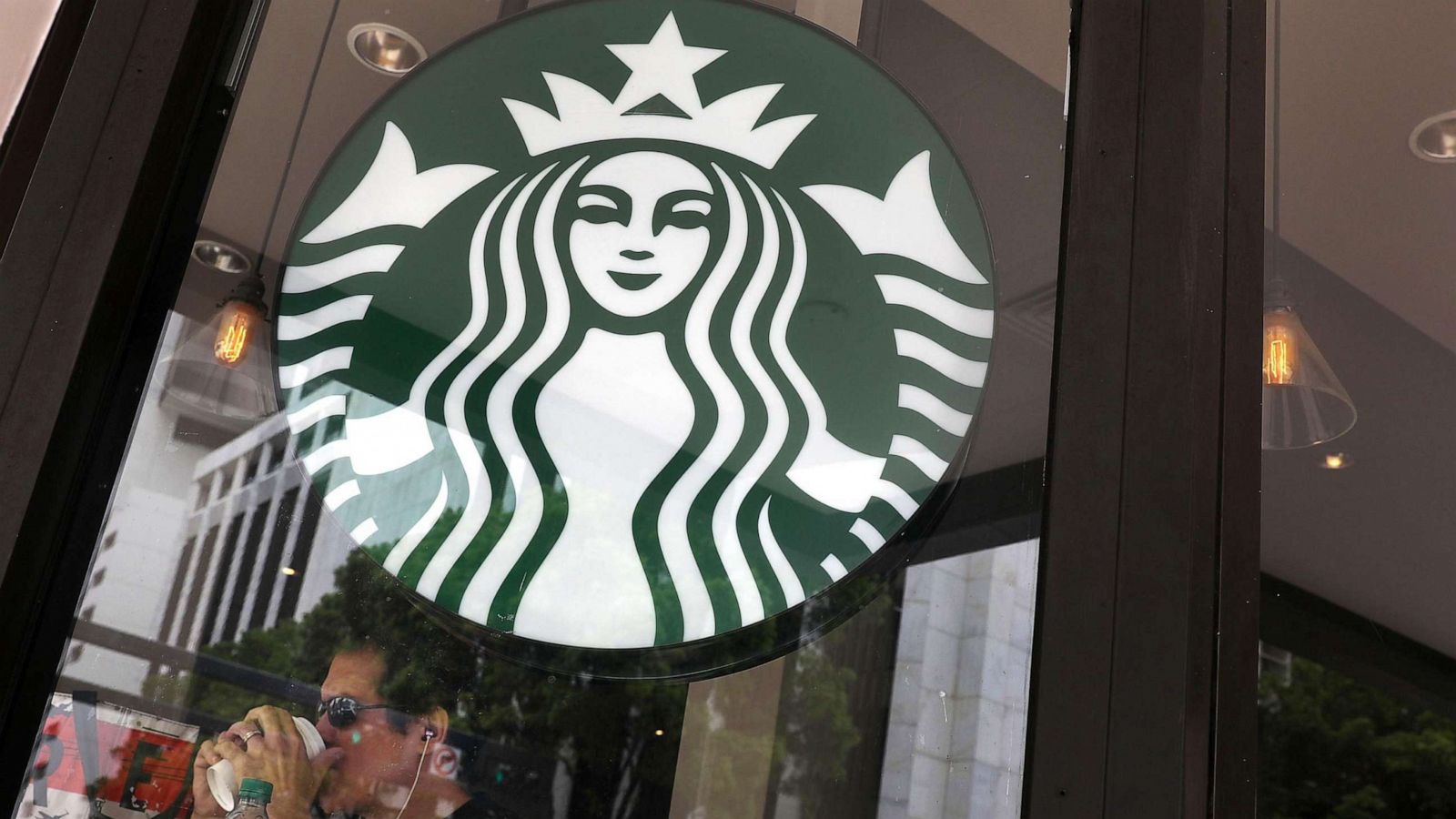 PHOTO: In this May 29, 2018, file photo, a customer enjoys his drink before the Starbucks store closes during a day allotted for company wide anti-bias training, in Miami, Florida