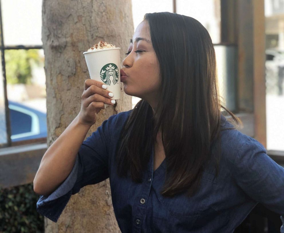 PHOTO: ABC News Fellow Angeline Bernabe holds a Pumpkin Spice Latte at a Starbucks location on Melrose Avenue in Los Angeles.