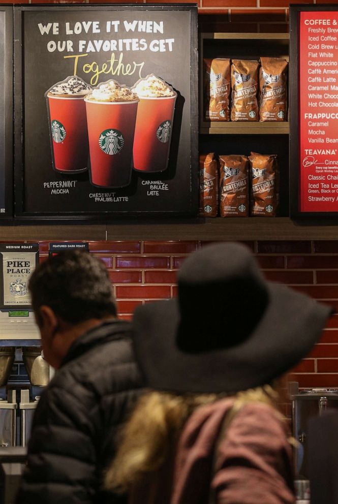 PHOTO: Starbucks red cups are seen on a poster New York, Nov. 12, 2015.