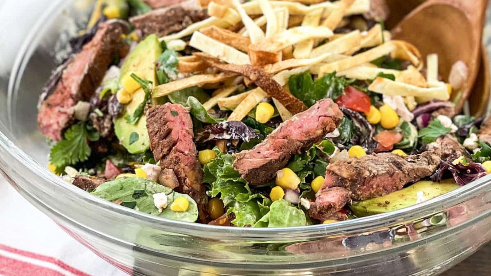 PHOTO: A southwestern steak salad with corn and crispy tortilla strips.