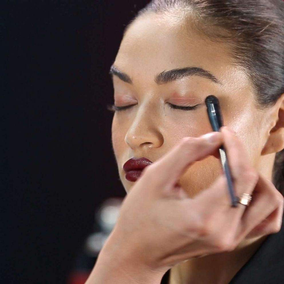 PHOTO: Patrick Ta applies blush onto model Shanina Shaik's eyelid.