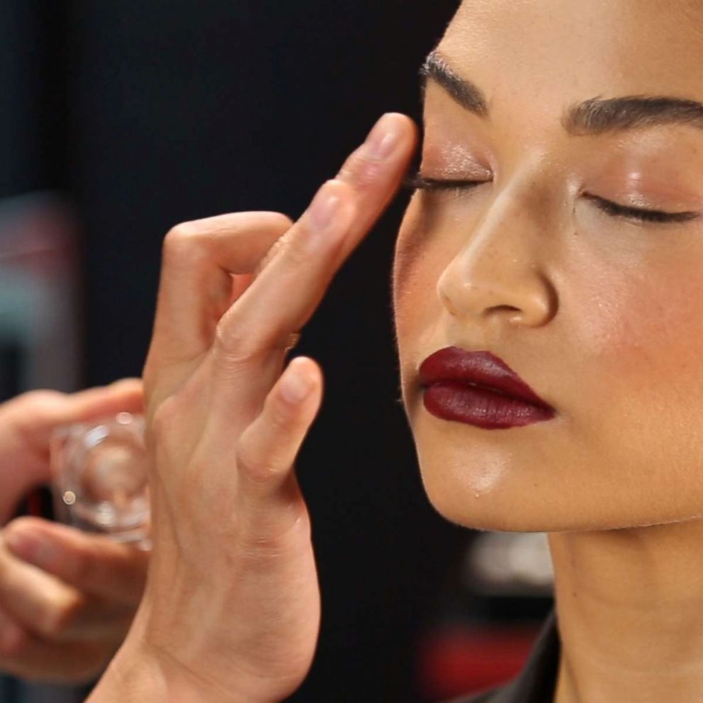 PHOTO: Patrick Ta applies Shiseido Aura Dew highlighting powder to Shanina Shaik's eyelid.