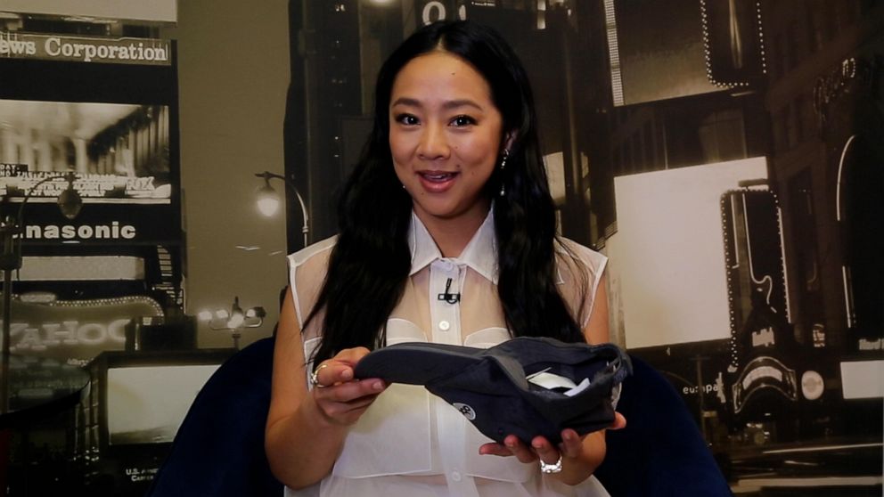 PHOTO: ctress Stephanie Hsu holds up a hat full of questions written on paper while at Times Square Studios.