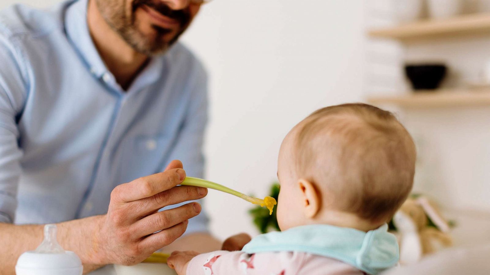 PHOTO: A father feeds a baby.