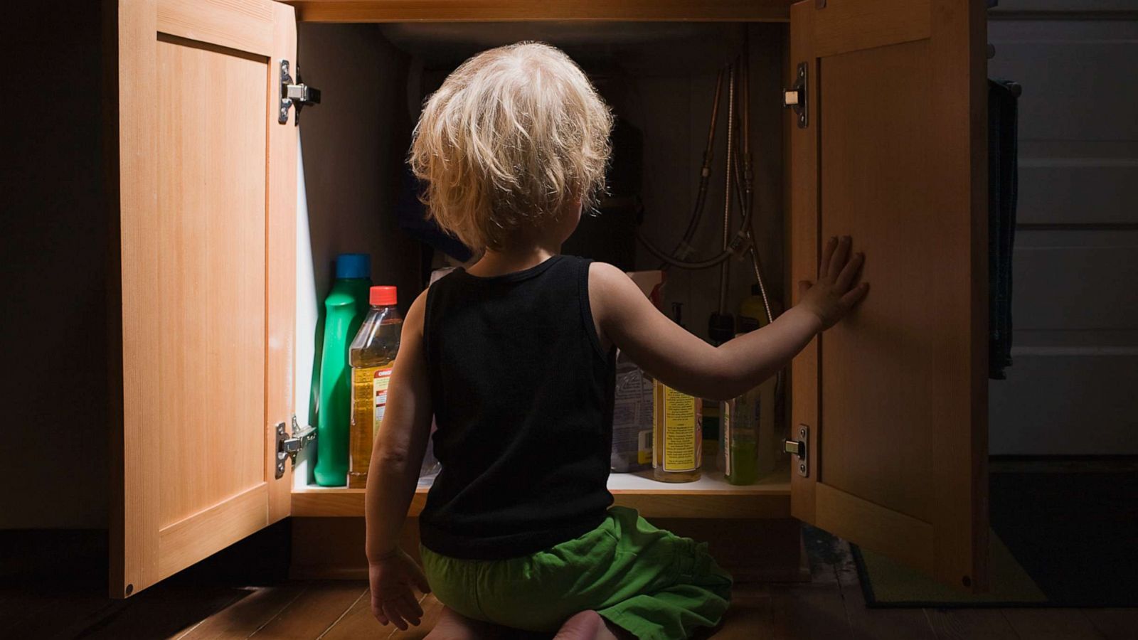 PHOTO: Stock photo of child looking at cleaning products.