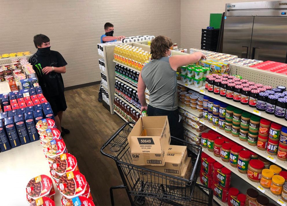 PHOTO: Student managers stock the shelves for the grocery store.