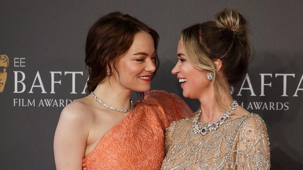 PHOTO: Emma Stone and Emily Blunt pose on the red carpet upon arrival at the BAFTA British Academy Film Awards at the Royal Festival Hall, Southbank Centre, in London, on February 18, 2024.