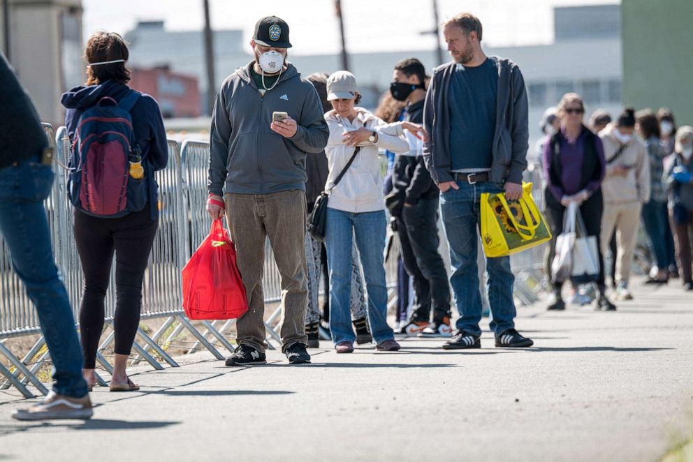 PHOTO: People wait in line to enter at a Berkeley Bowl West store in Berkeley, Calif., March 31, 2020.
