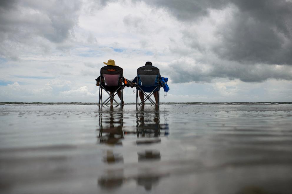 PHOTO: A couple sit on the beach before the arrival of Tropical Storm Beryl in Corpus Christi, Texas, July 7, 2024. 