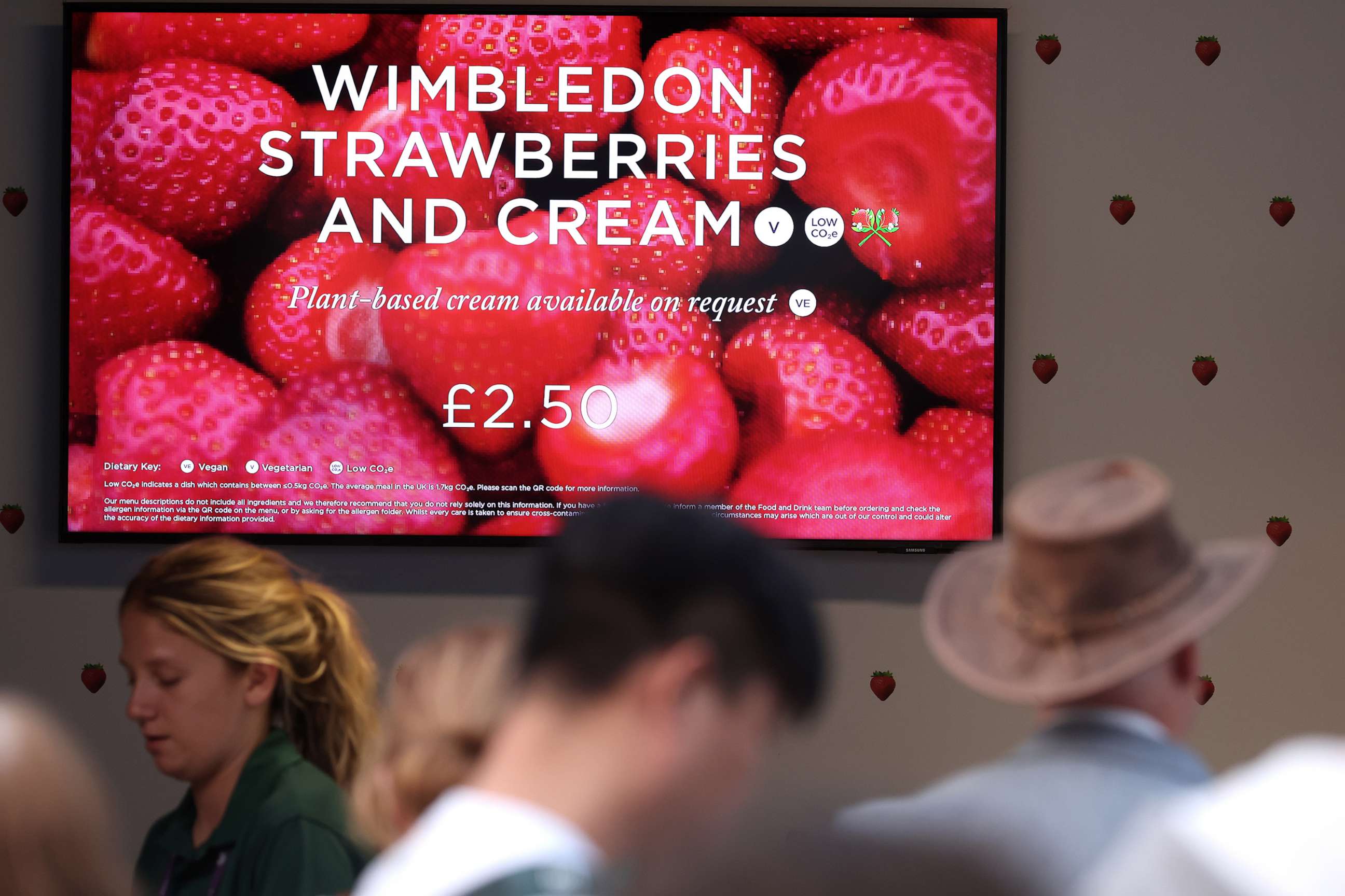 PHOTO: A sign advertises strawberries and cream during day seven of The Championships Wimbledon 2023, July 9, 2023 in London.