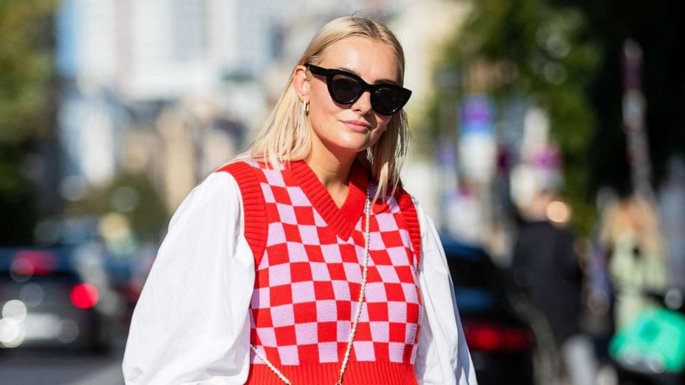 PHOTO: Pauline Riemis wears Adidas track suit pants, red checkered slipover and a white button shirt during About You Fashion Week, on Sept. 14, 2021 in Berlin.
