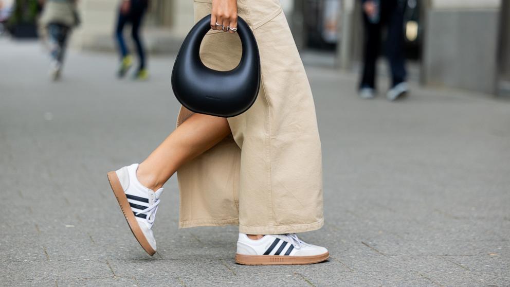 PHOTO: Jacqueline Zelwis wears sleeveless white 7forallmankind top, beige Herskind skirt, white Adidas sneakers, black Charles & Keith bag on May 5, 2024 in Berlin.