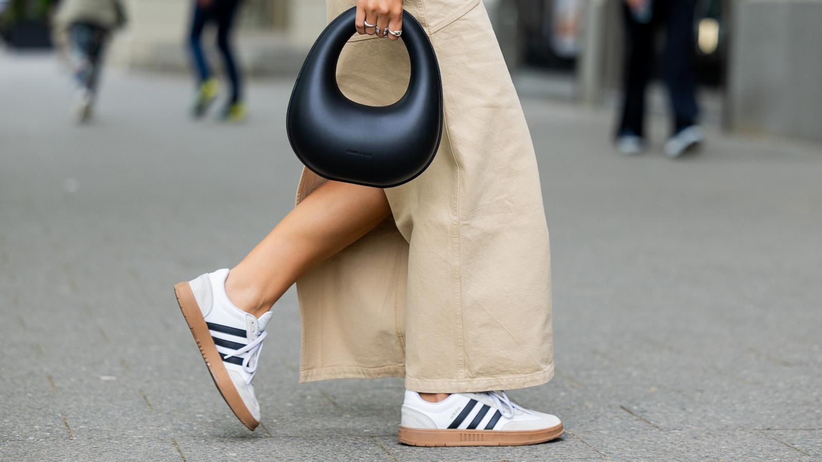 PHOTO: Jacqueline Zelwis wears sleeveless white 7forallmankind top, beige Herskind skirt, white Adidas sneakers, black Charles & Keith bag on May 5, 2024 in Berlin.