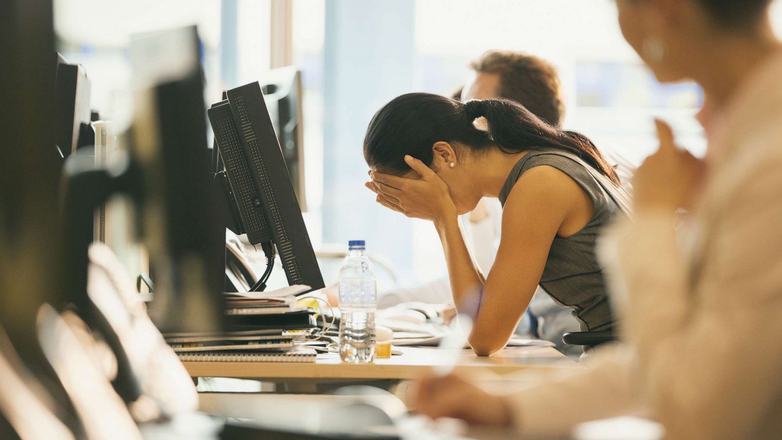 PHOTO: A woman sits at her desk at work in this undated stock photo.