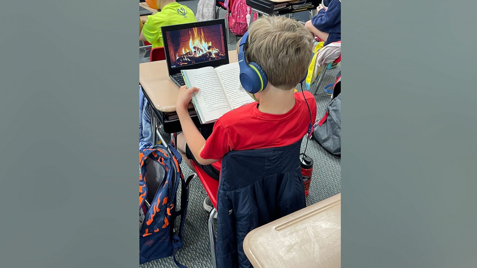 PHOTO: Eli Bey, 9, reading in front of a virtual fireplace.