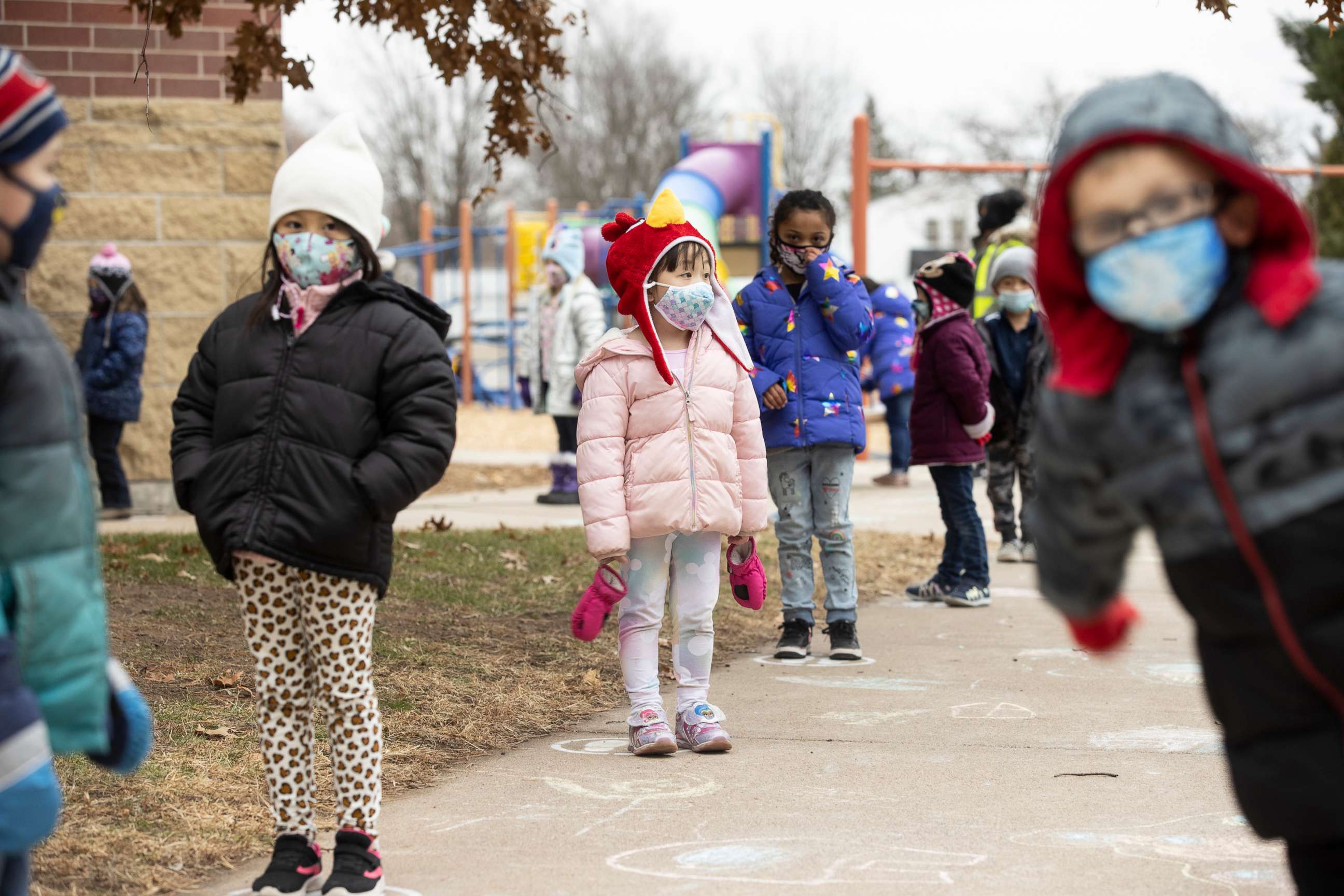 PHOTO: Students line up on designated spots after recess before returning to their classrooms at G.D. Jones Elementary in Wausau, Wis., Dec. 7, 2020.